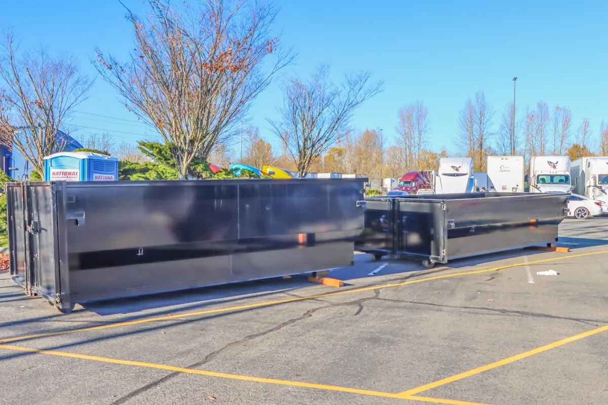 Professional dumpster rental service with roll-off container on residential driveway in Silver Firs